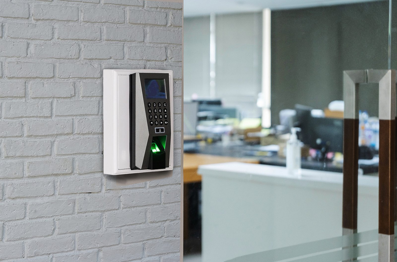 Finger print scan machine on wall near entrance door office. Finger print scan machine on wall near entrance door office.